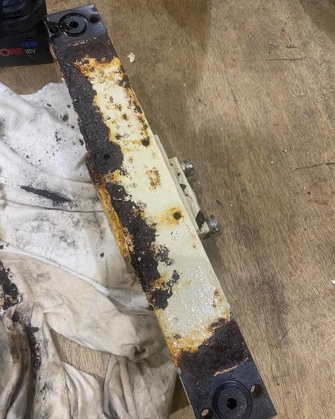 A worn Acto distribution bar, corroded