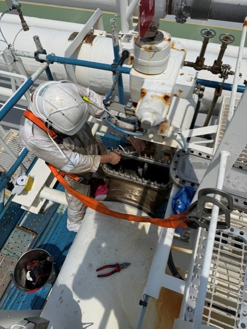 Technician servicing a KSB Amri valve and actuator on board