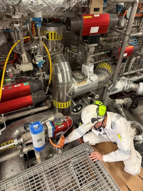 Technician working on equipment inside an FGSS room